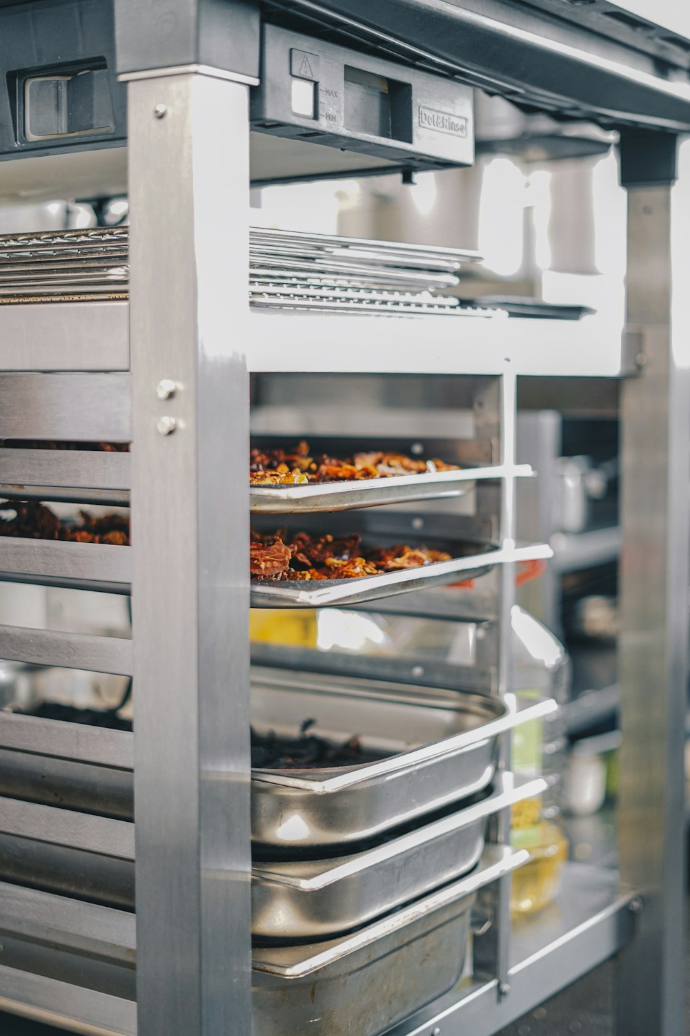 a commercial oven with several trays of food in it
