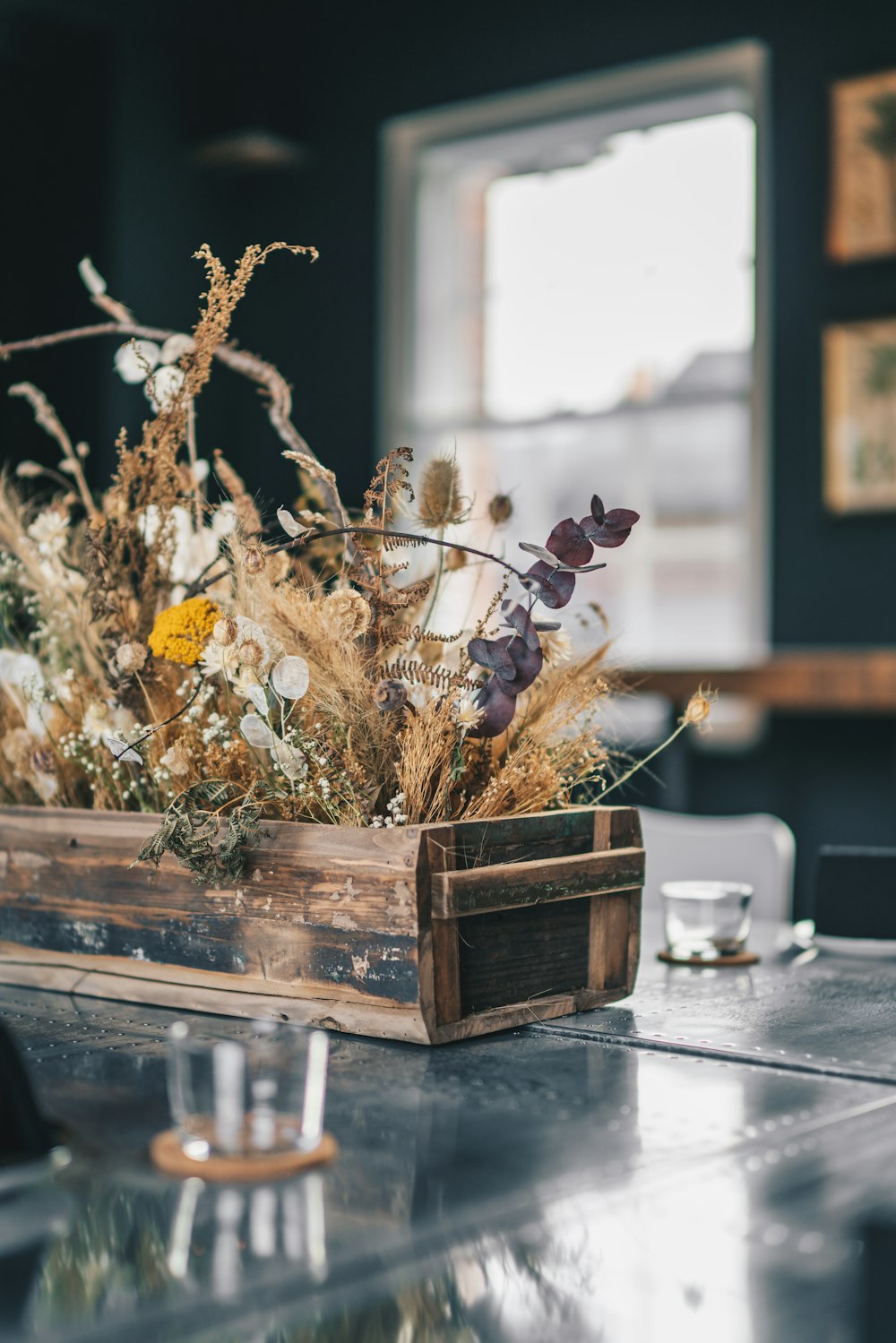 a wooden crate filled with flowers on top of a table