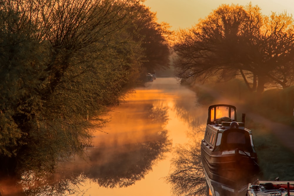 a boat on a river with trees in the background