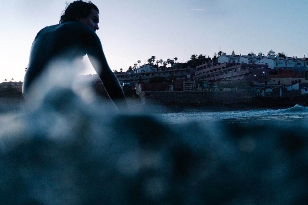 a man riding a wave on top of a surfboard