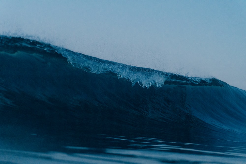 a person riding a surfboard on a wave in the ocean