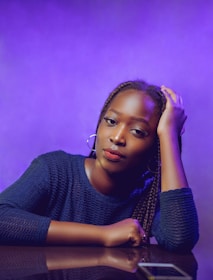 A hair stylist wearing the Reflection Palette Bracelet while working, highlighting its chic black and white color scheme.