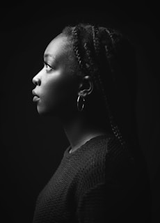 a woman with braids in a black and white photo