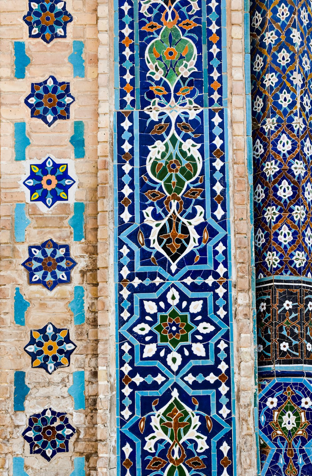 a blue and white tiled wall with a window