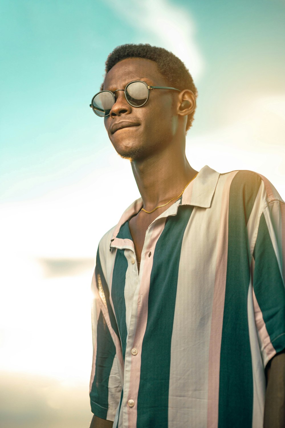 a man in a striped shirt and sunglasses