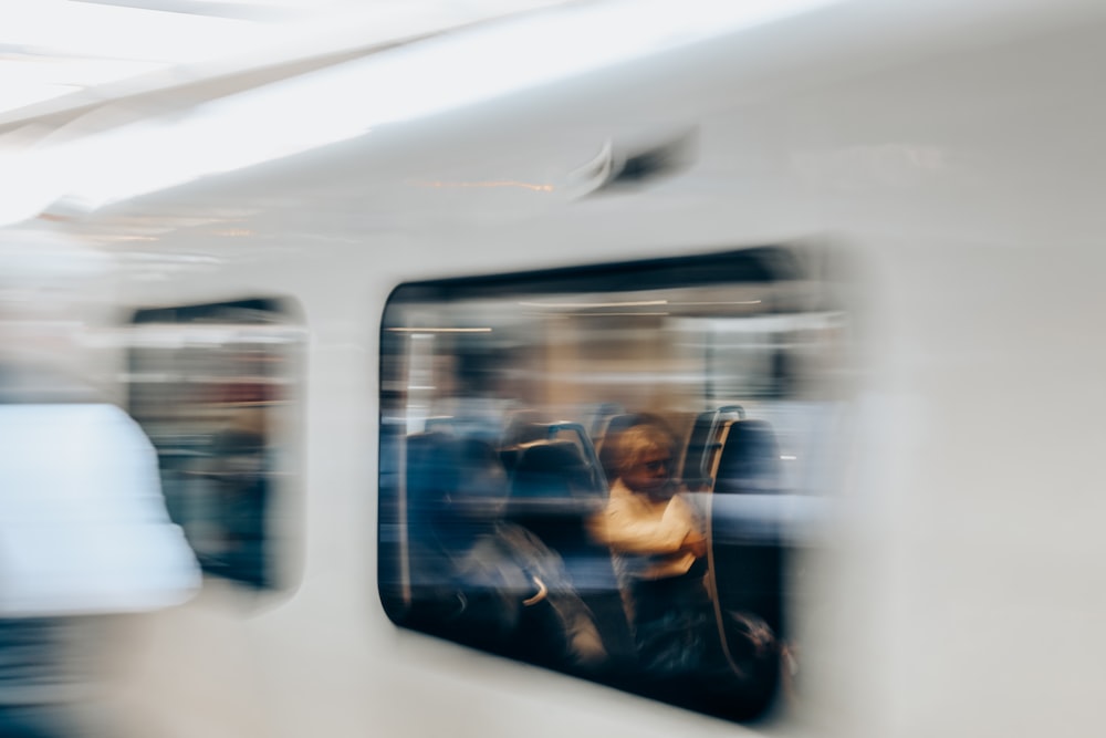 a blurry photo of a person sitting in a train