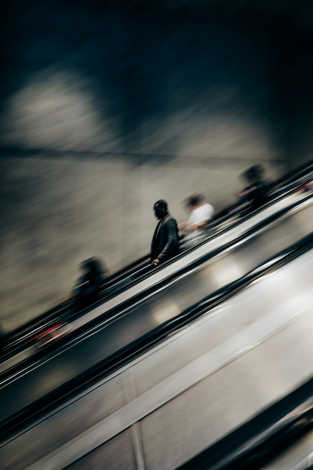 a person riding an escalator with a skateboard