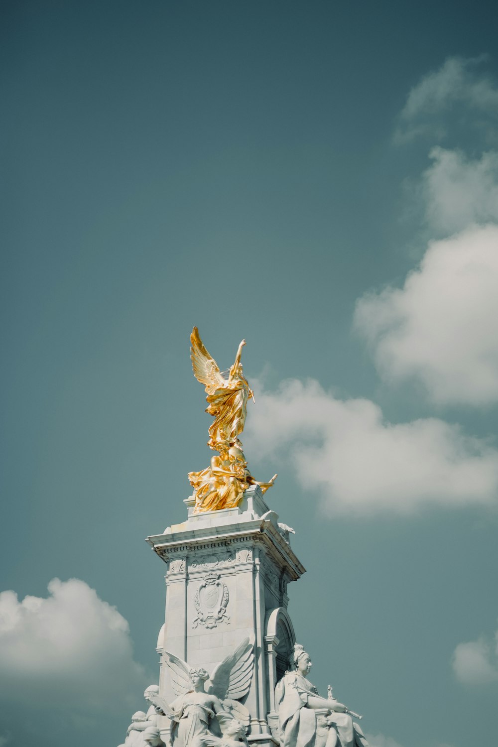 a statue with a gold statue on top of it