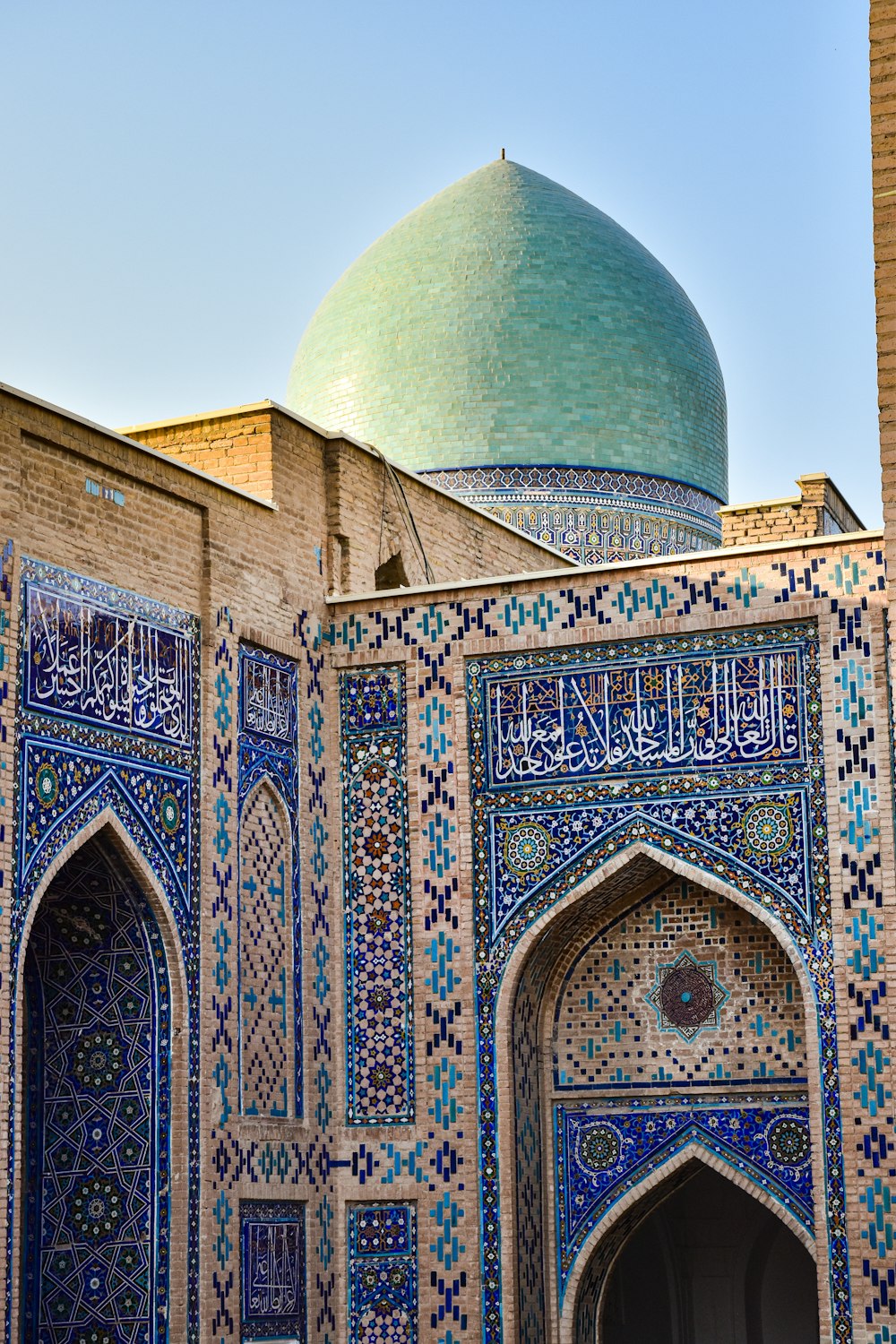a blue and white building with a green dome