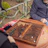 Two friends discussing game rankings on a smartphone outdoors.