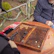 Two friends discussing game rankings on a smartphone outdoors.