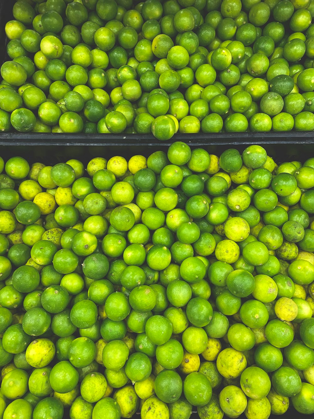 two bins filled with limes and lemons