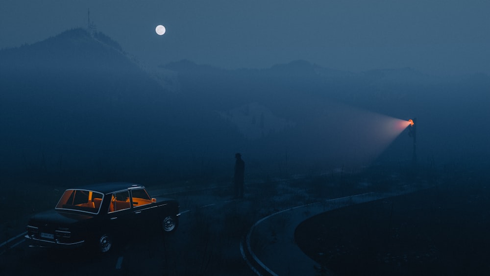 a car driving down a road at night