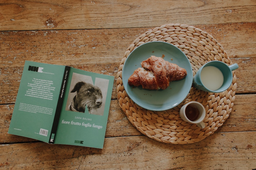 a plate of food and a book on a wooden table