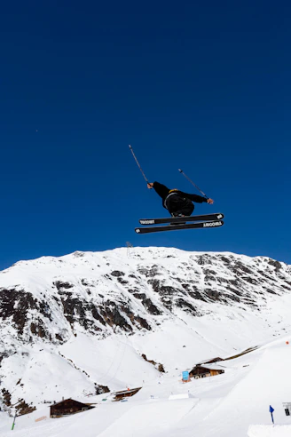 a man flying through the air while riding skis