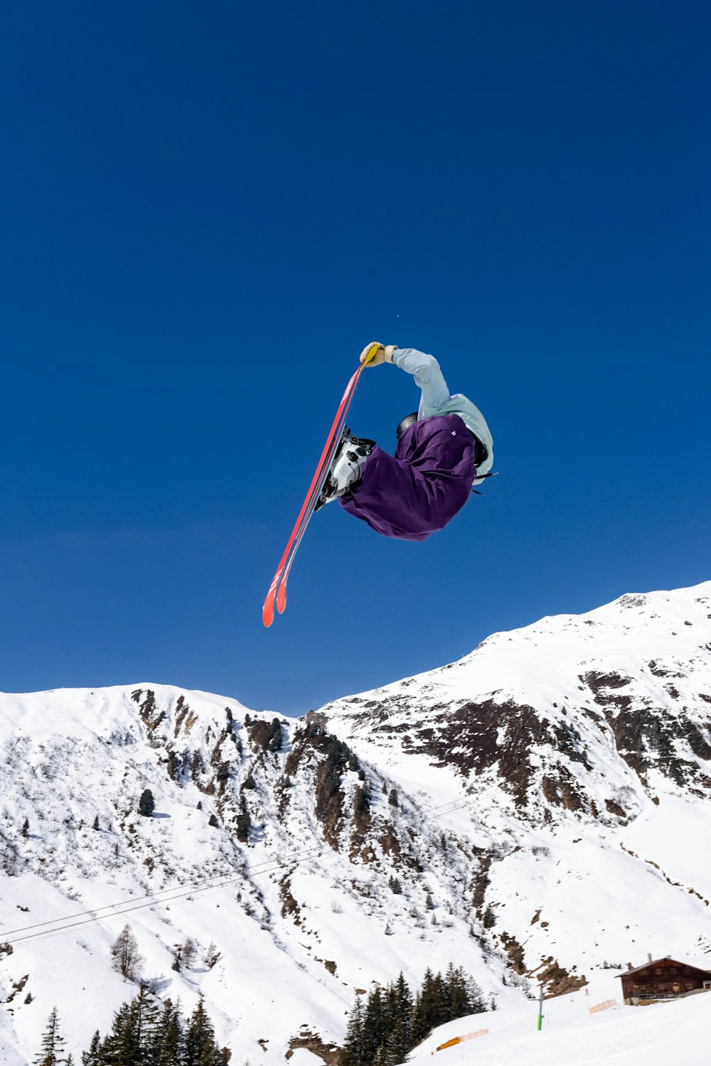 a man flying through the air while riding a snowboard