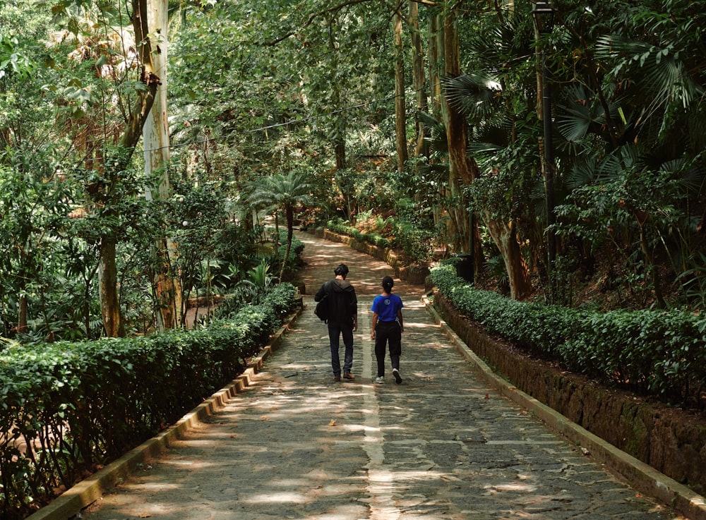 a couple of people that are walking down a path