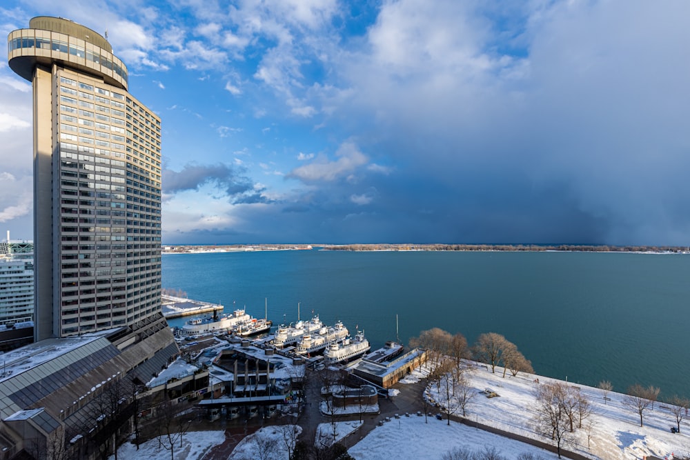 a large body of water next to a tall building