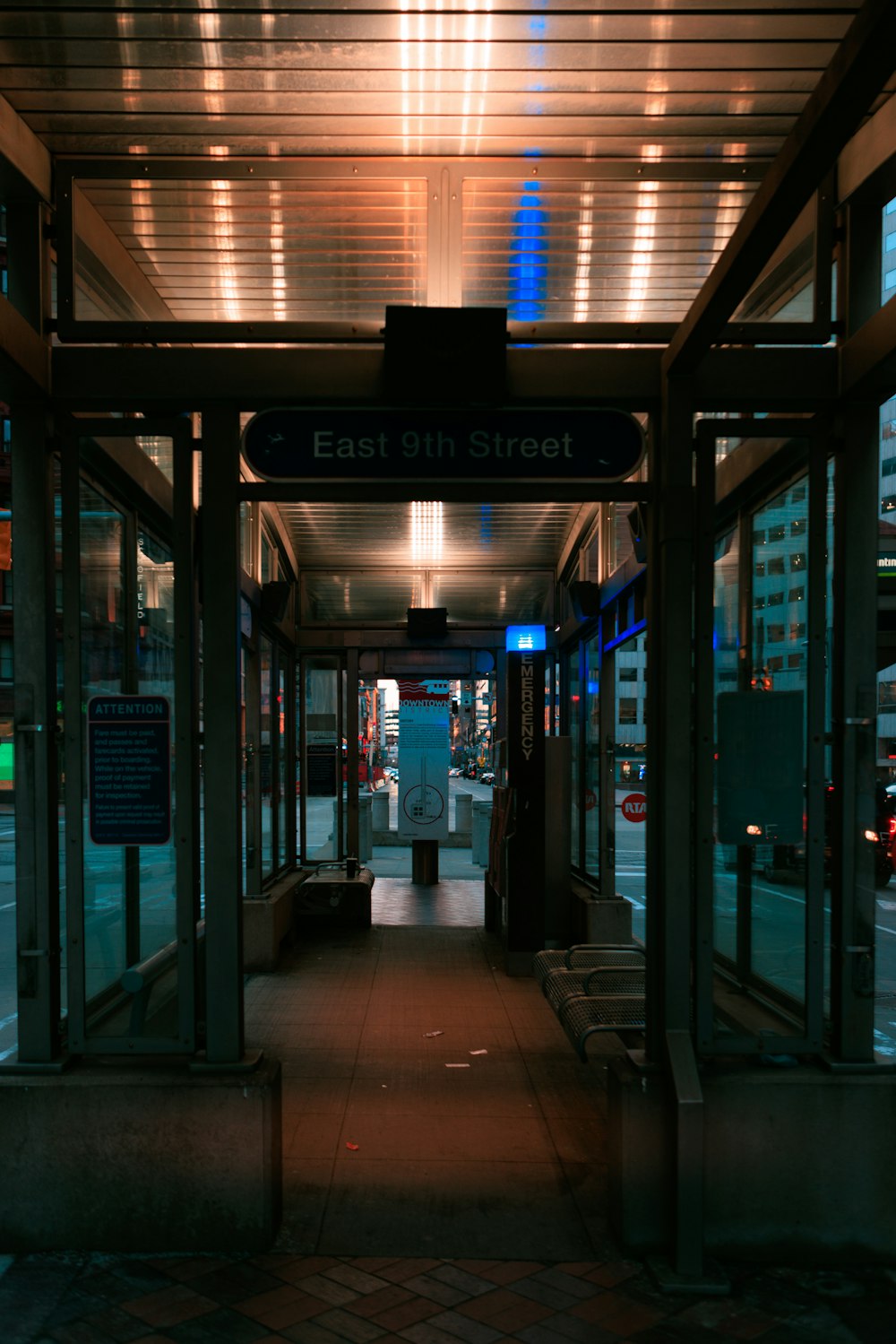 an empty bus stop at night with lights on