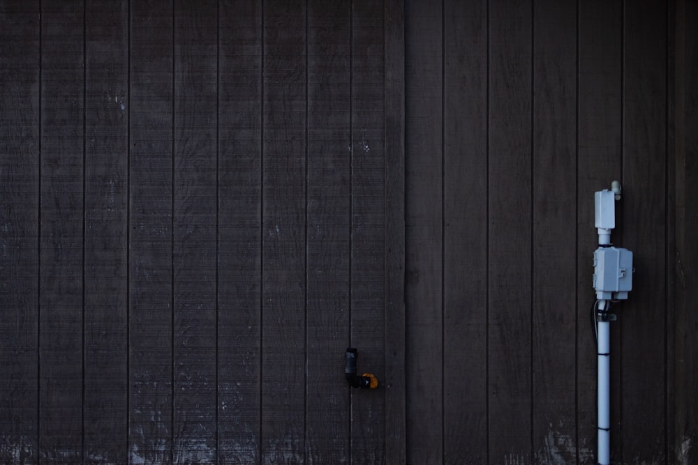 a black garage door with a light on it