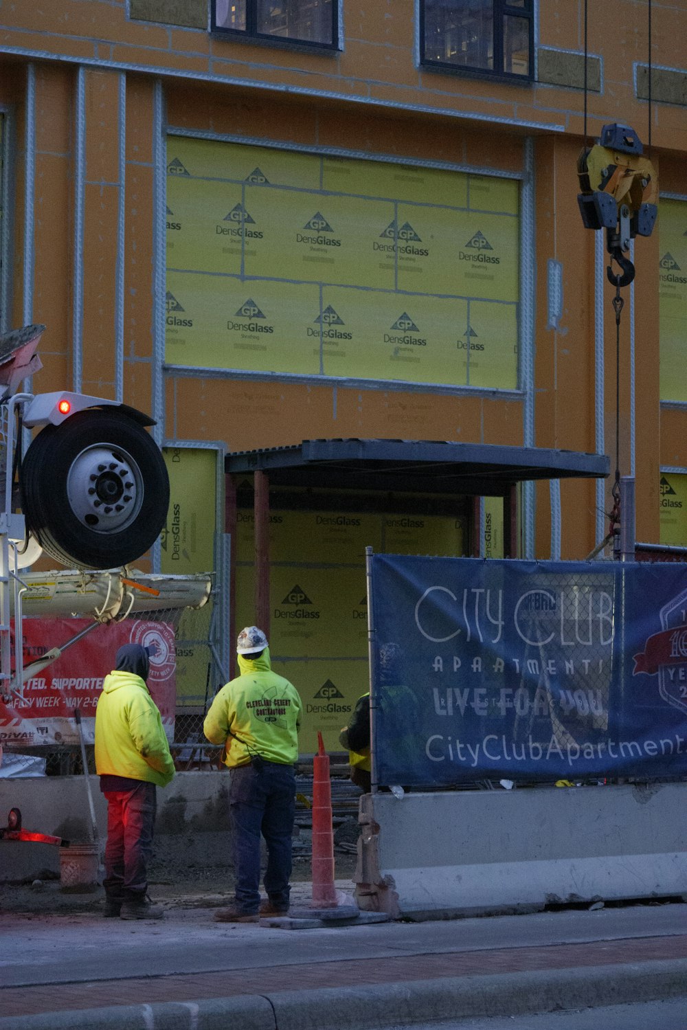 a couple of men standing in front of a building under construction