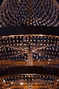 A warm, elegant chandelier illuminating a luxurious hotel lobby