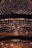 A large, ornate chandelier with numerous crystal pendants hanging in intricate patterns. The lighting creates a warm glow, enhancing the elegance and adding a sense of luxury.
