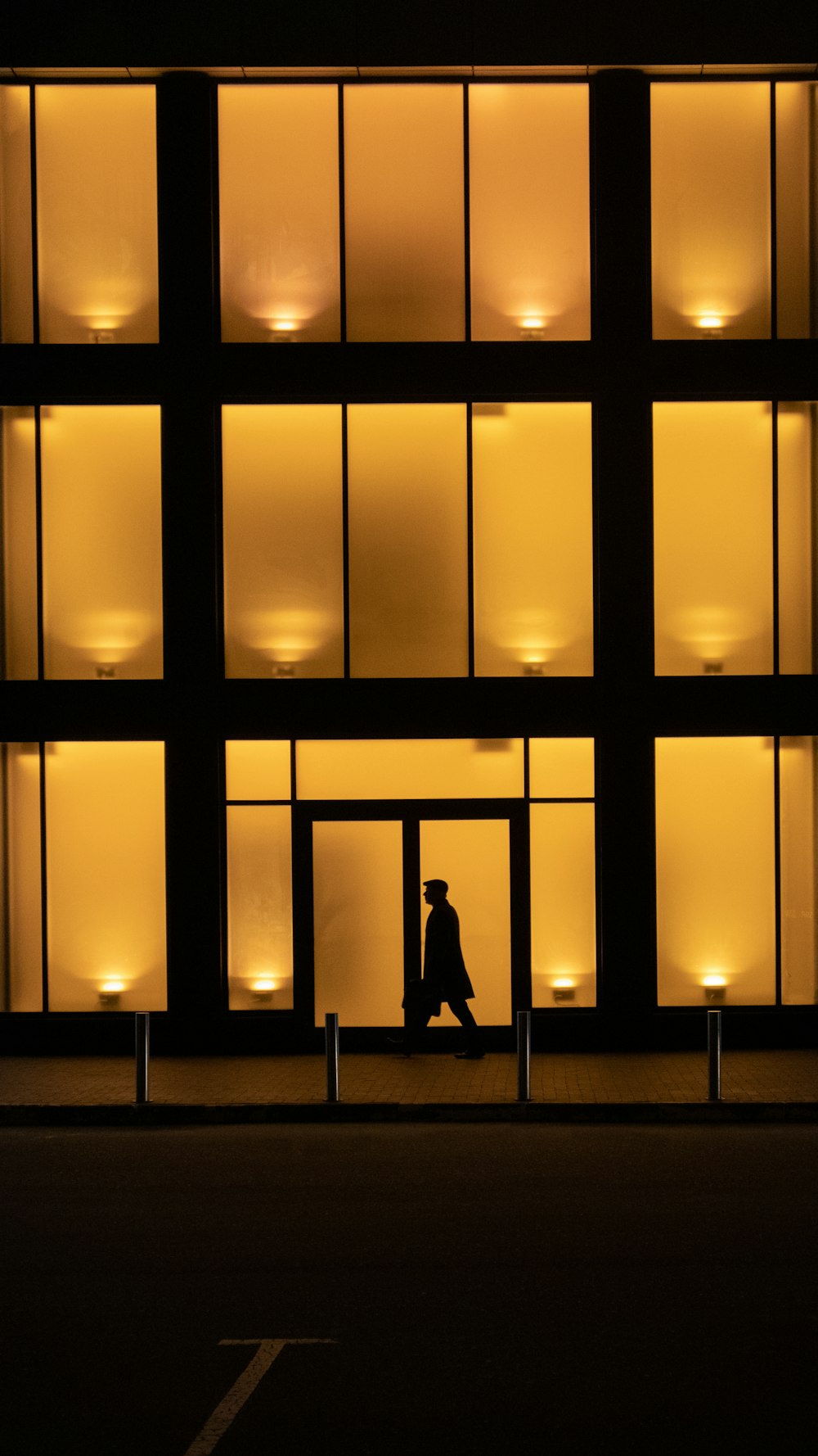 a person sitting on a bench in front of a building