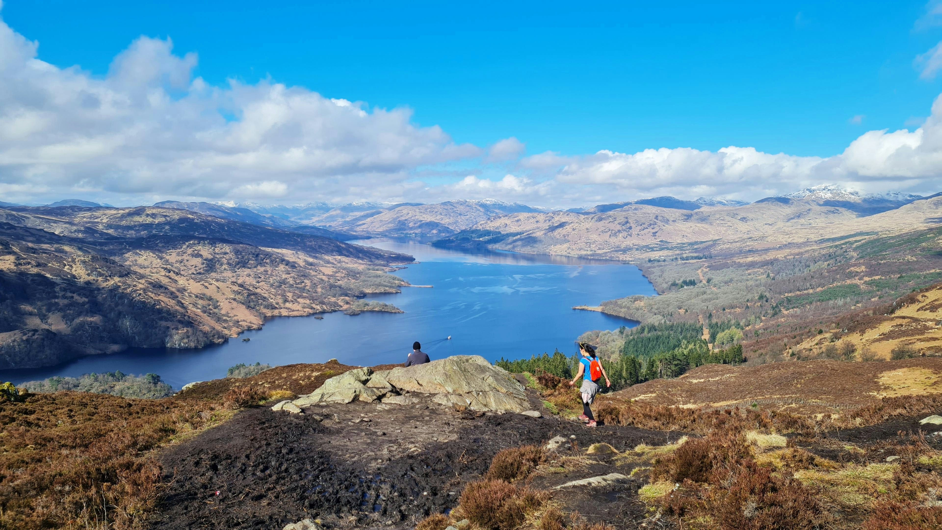 a couple of people standing on top of a mountain