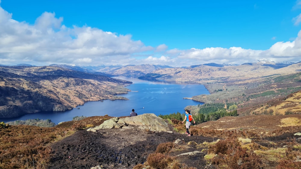 a couple of people standing on top of a mountain