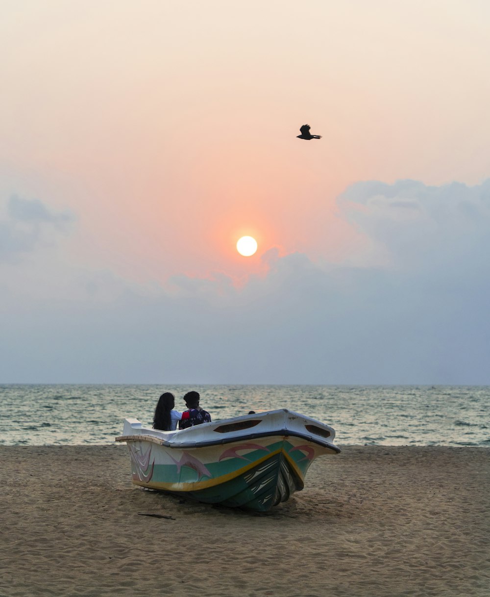 a boat sitting on top of a sandy beach