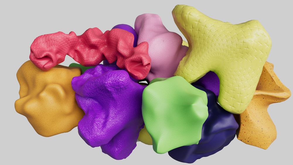 a bunch of different colored toys on a gray background