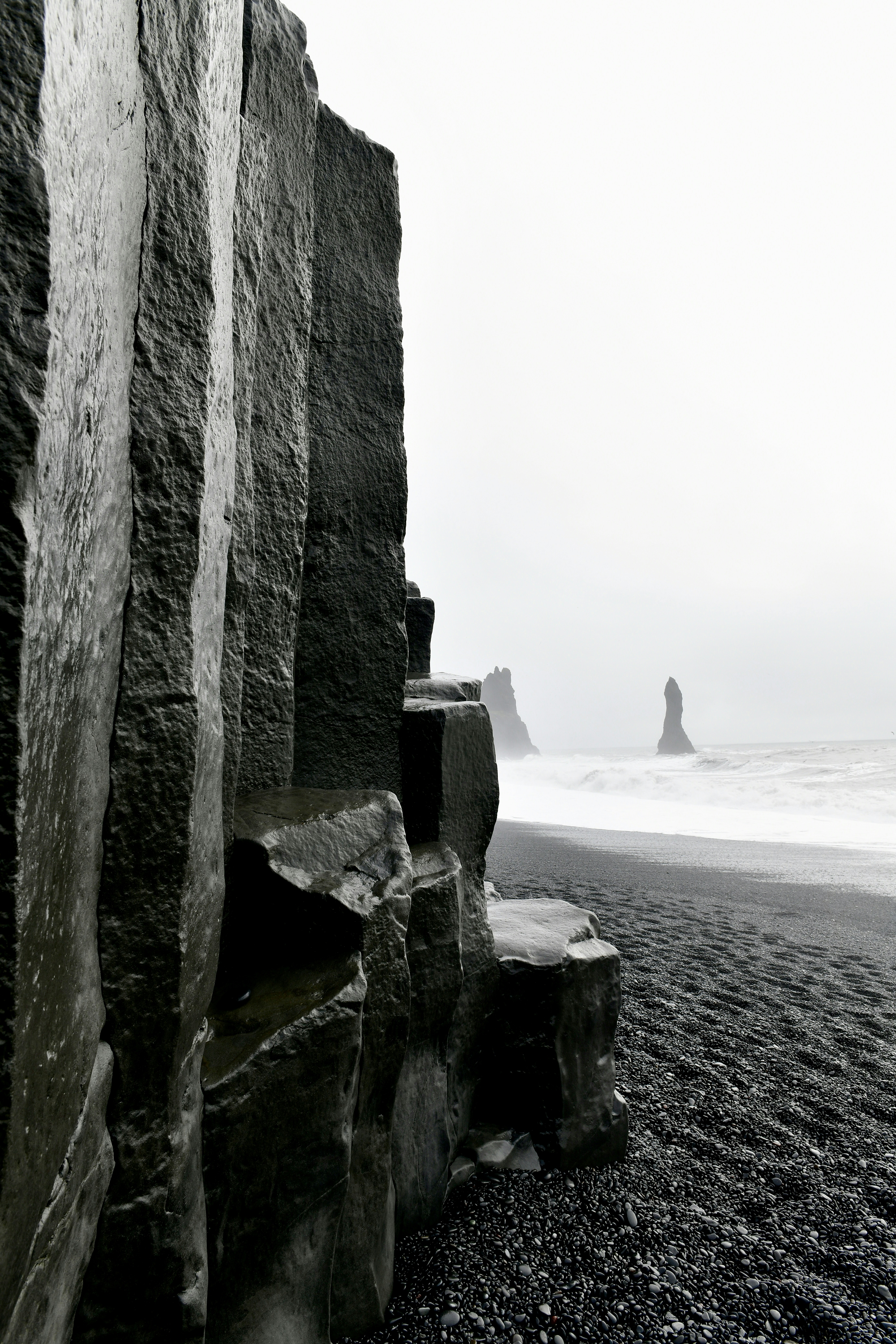 a black and white photo of a rocky beach