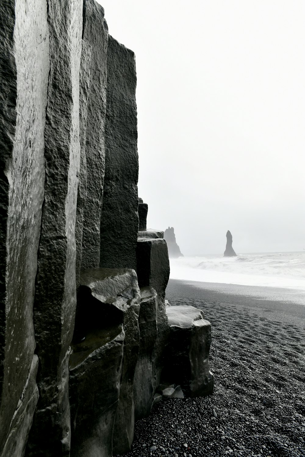 a black and white photo of a rocky beach