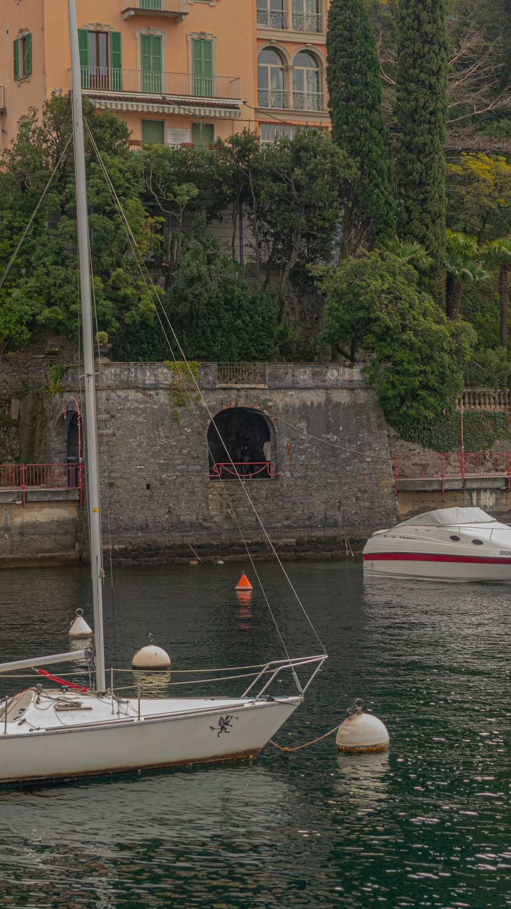 a sailboat in a body of water near a building