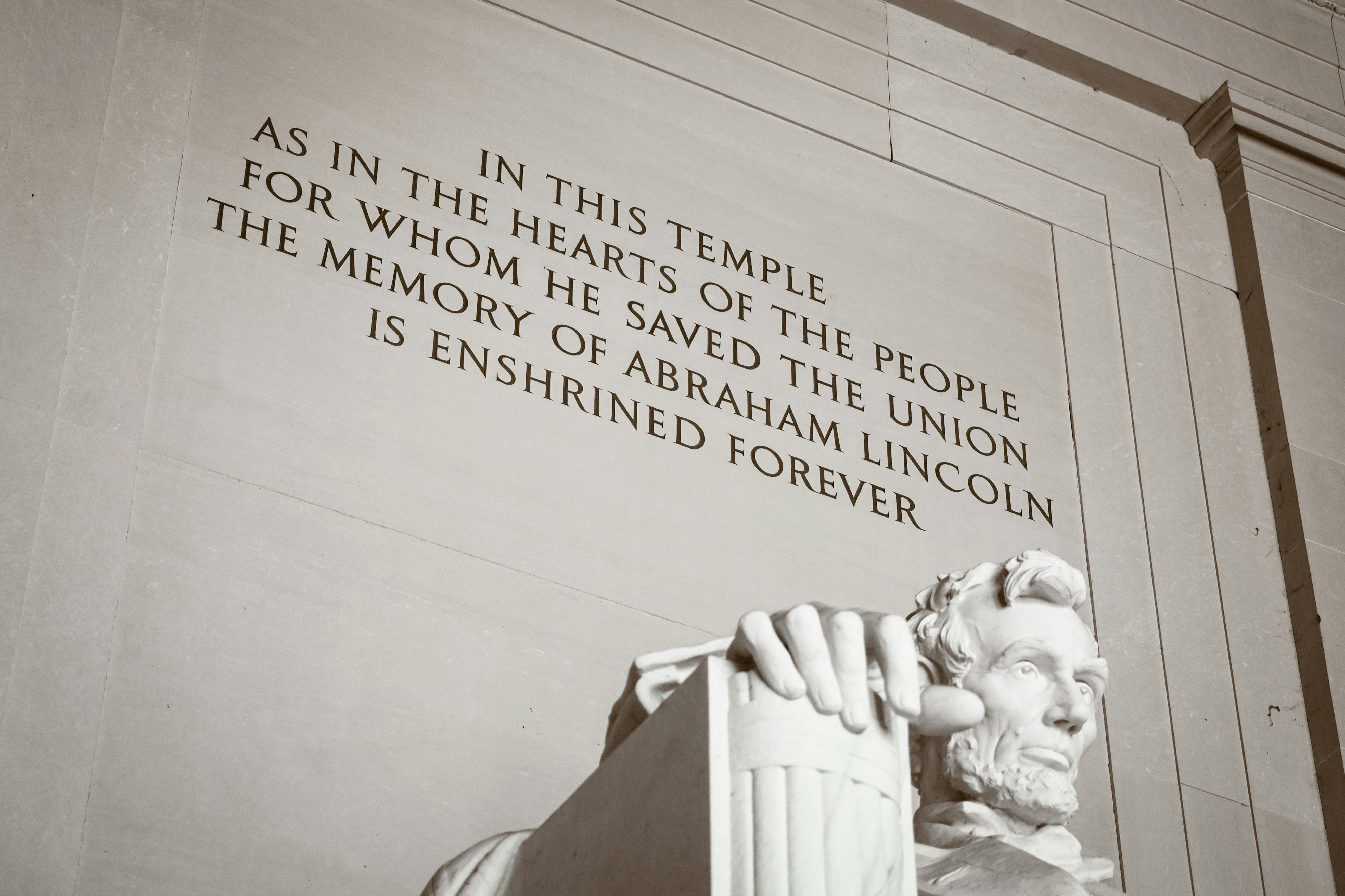 a statue of abraham lincoln in front of the lincoln memorial