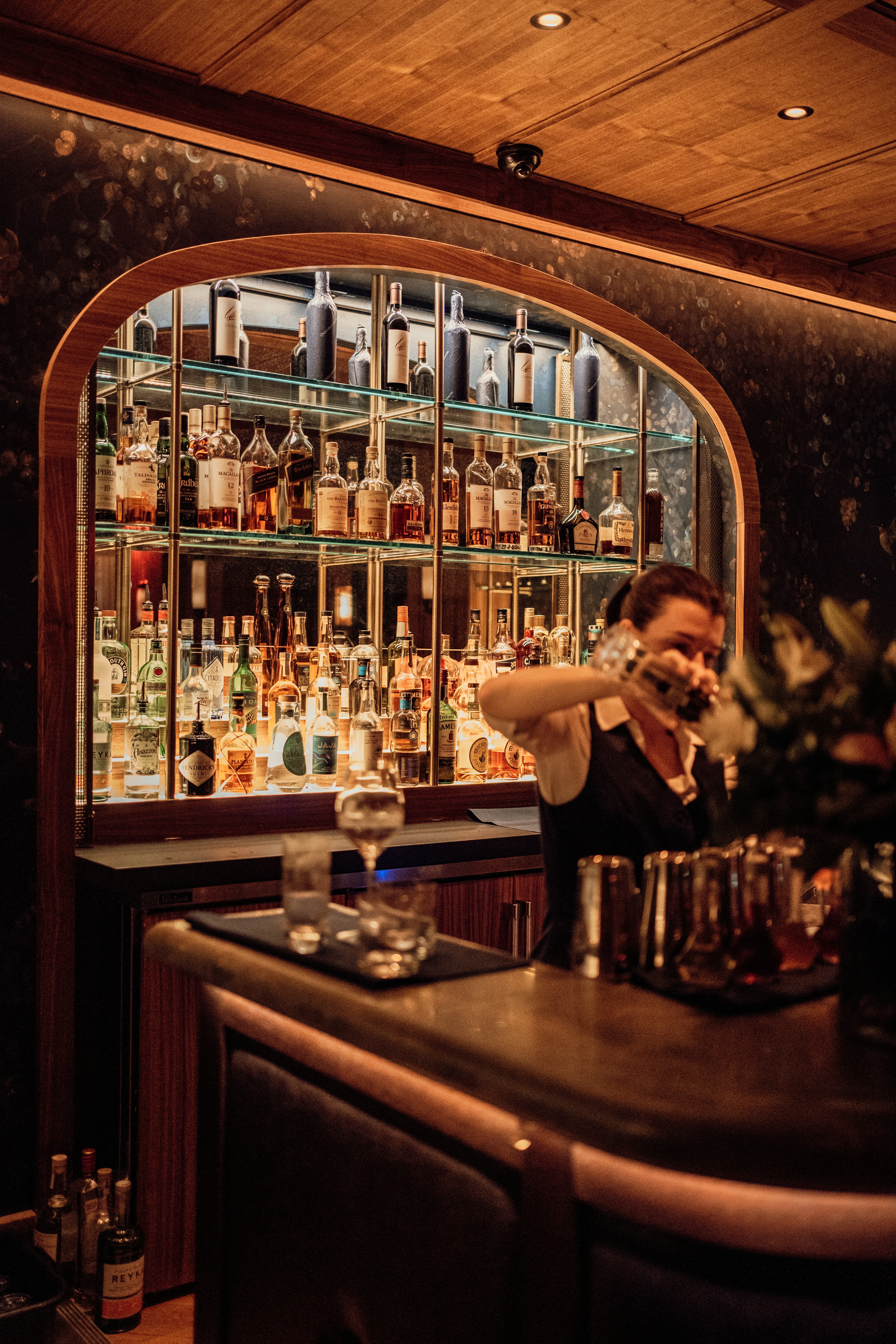 Bartender carefully crafting cocktails in a quiet intimate bar atmosphere
