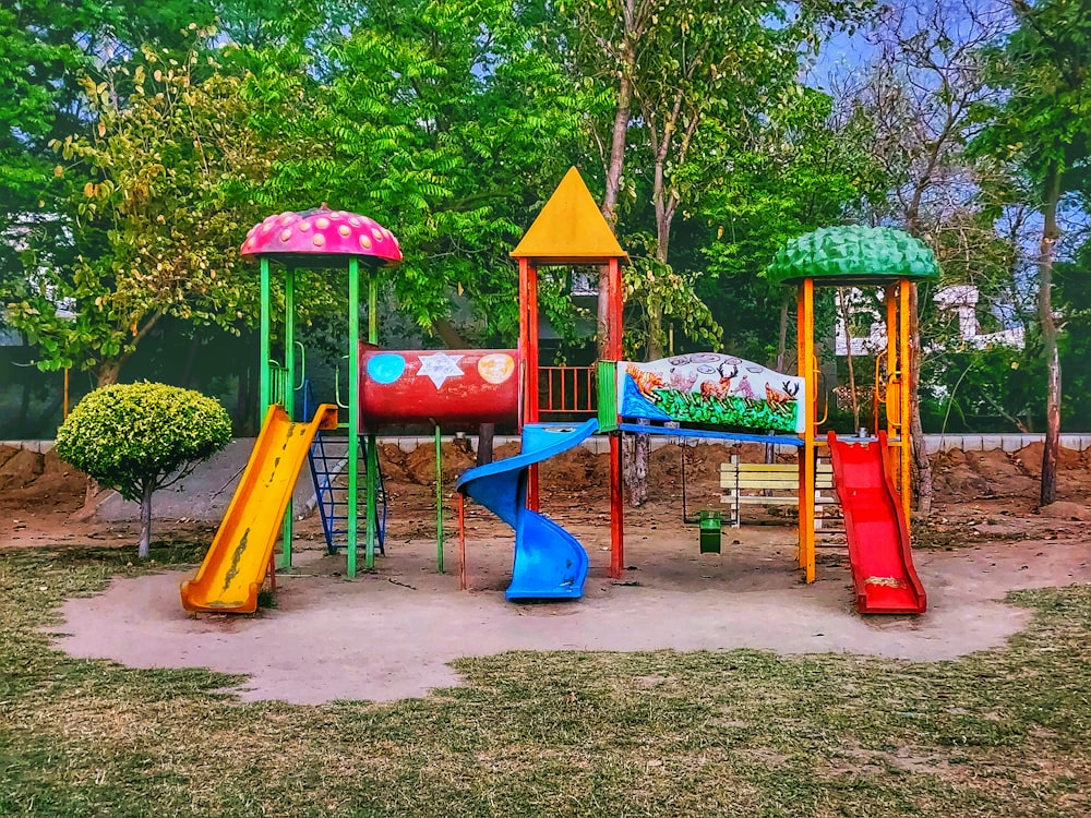 a colorful playground with a slide and climbing frame