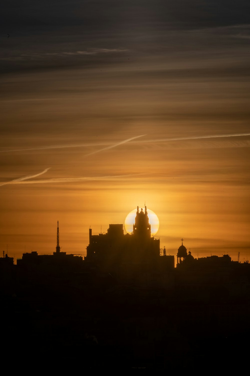 the sun is setting over a city skyline