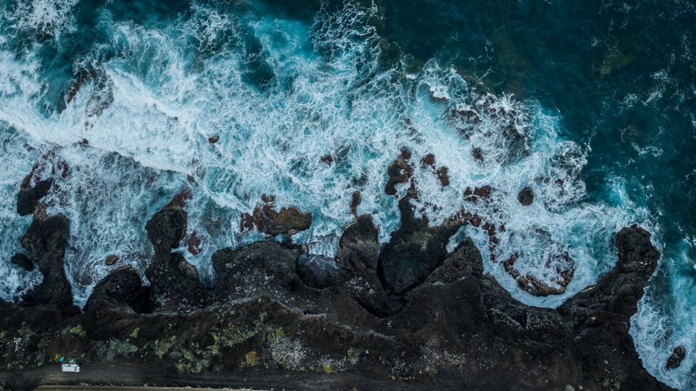 a bird's eye view of the ocean and rocks