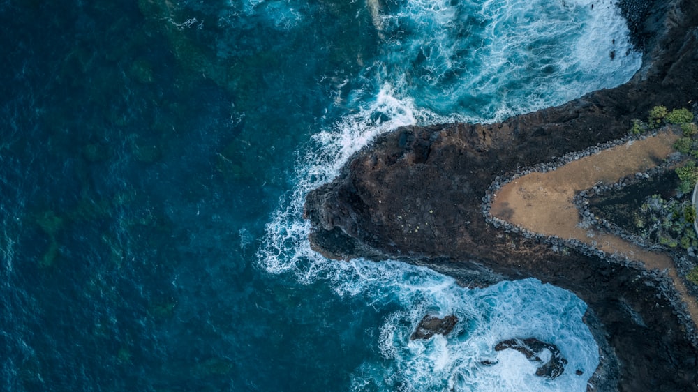 a bird's eye view of the ocean and rocks