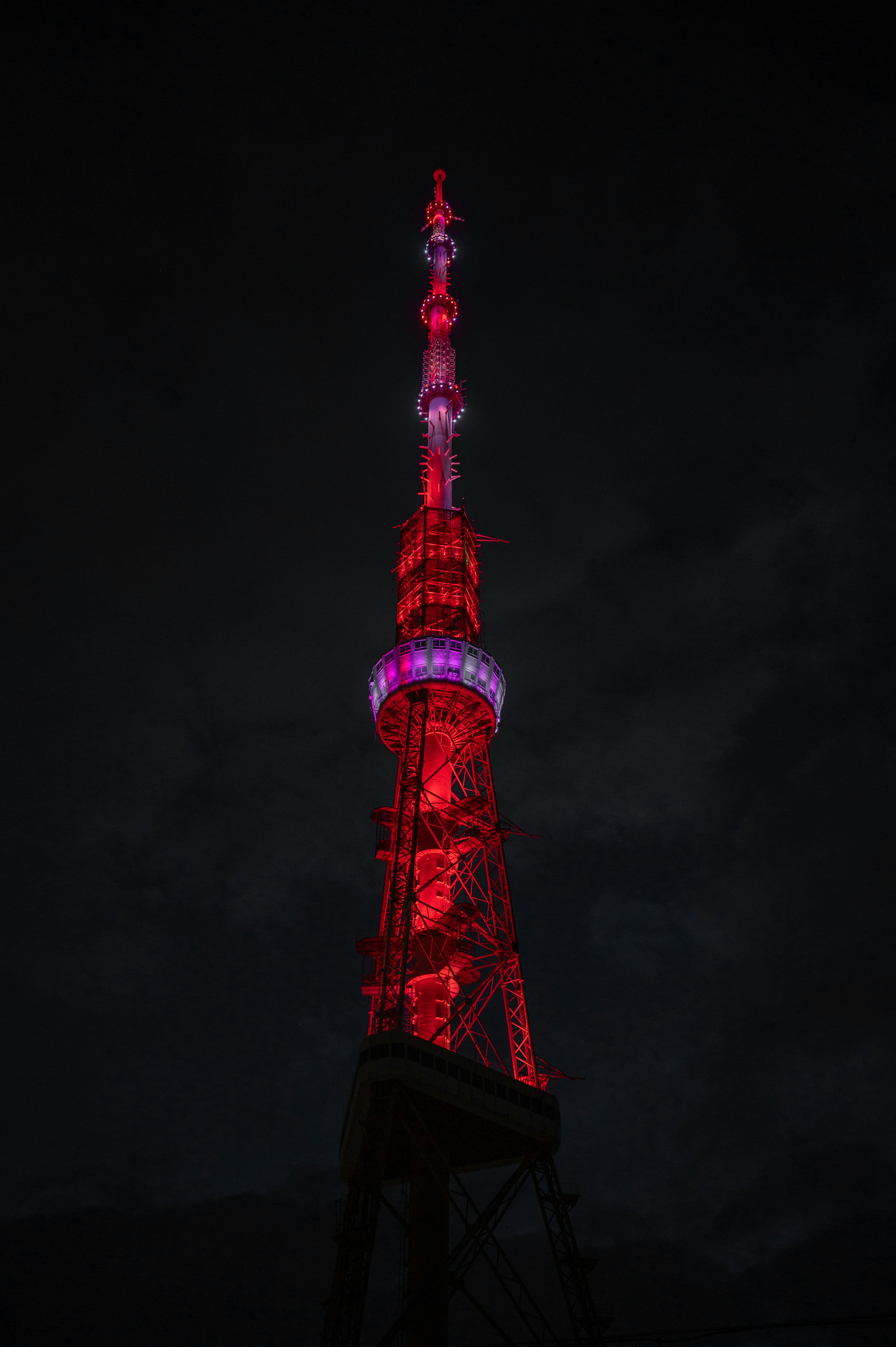 a very tall tower lit up at night