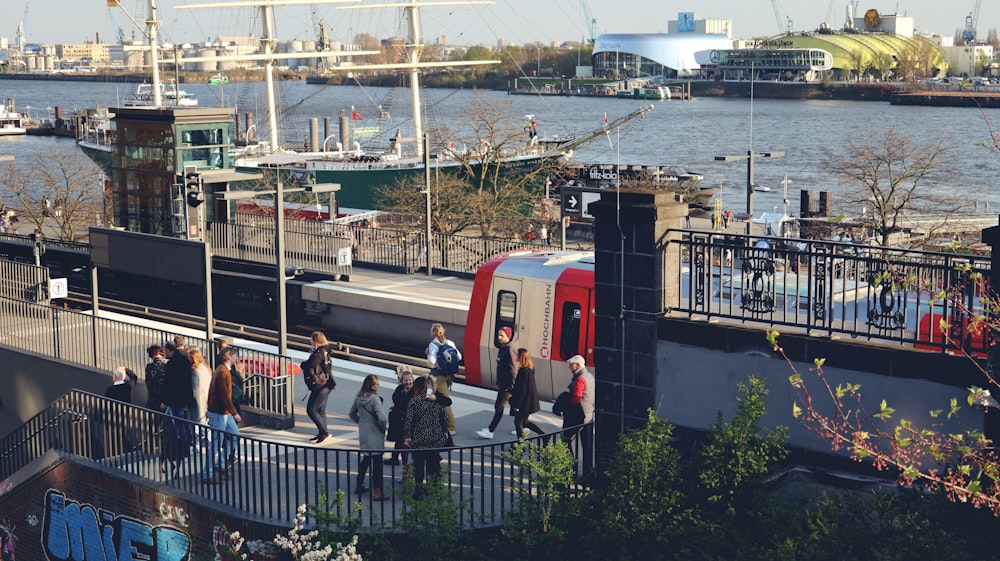 a group of people standing on a platform next to a train