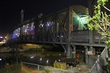 Public infrastructure project showing a bridge with deep navy and metallic gold accents in the design.