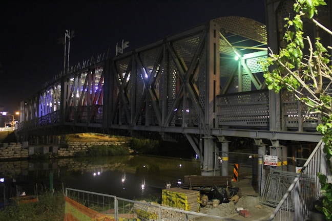 Public infrastructure project showing a bridge with deep navy and metallic gold accents in the design.
