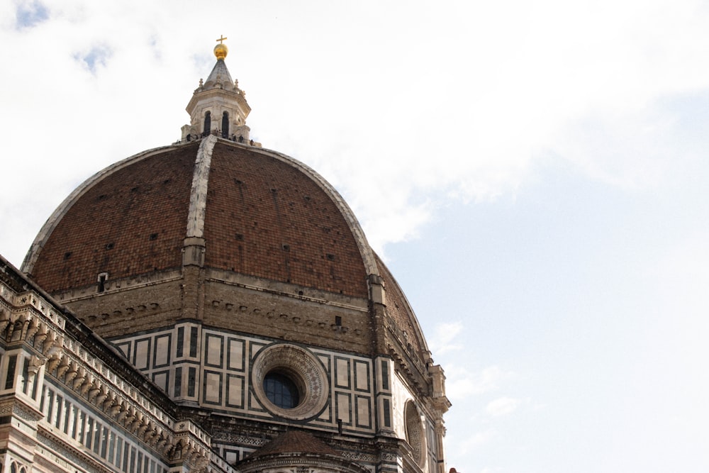 a tall building with a dome and a clock on it