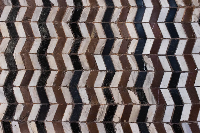 Chevron floor of white, black and brown marble strips