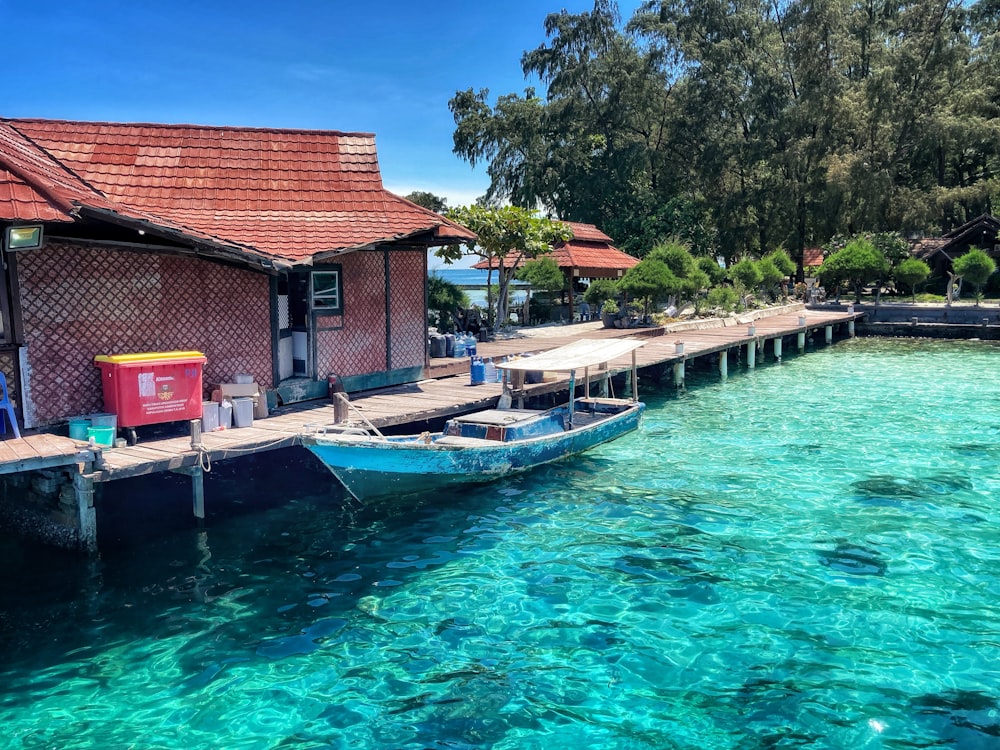 a boat is docked at a pier in the water