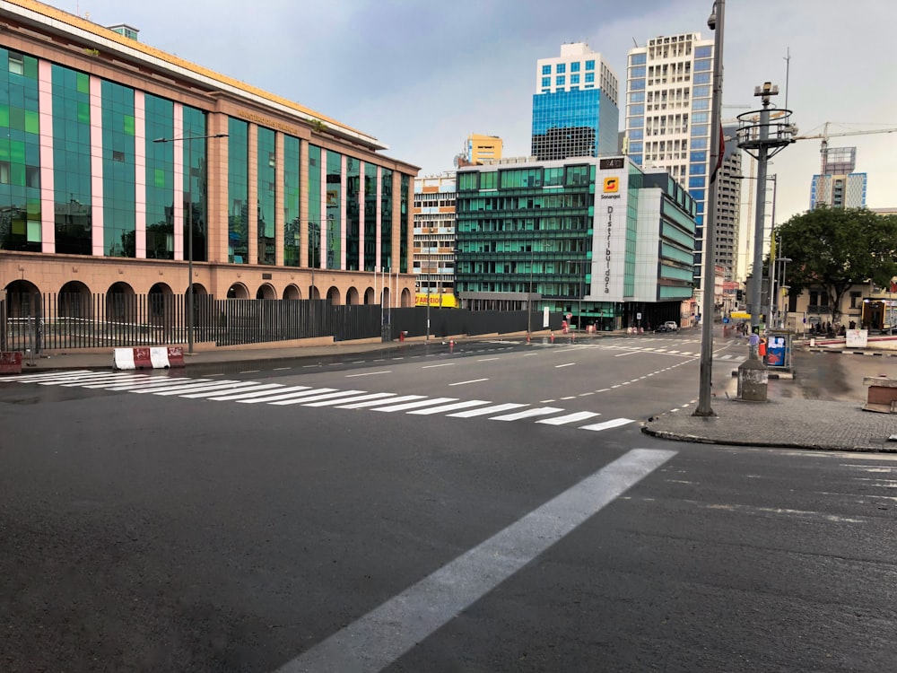 an empty street in a city with tall buildings