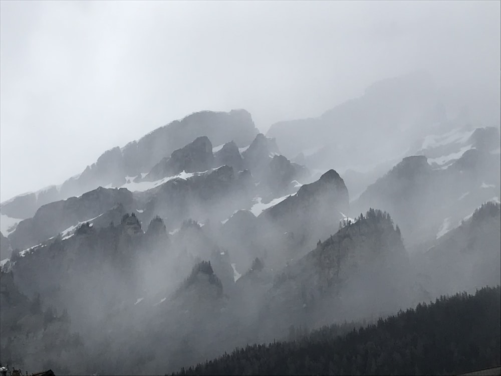 a mountain range covered in fog and clouds